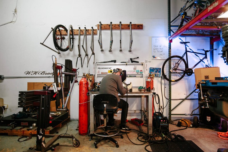 Brad Hodges of W.H. Bradford Design welding a bike frame. Photo by Angel Perez