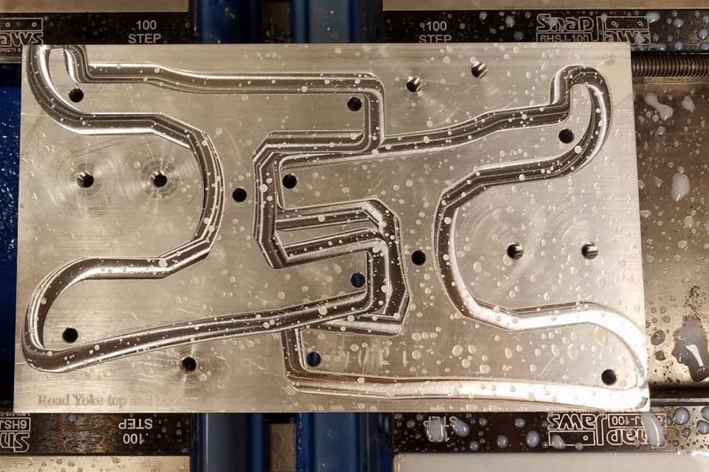 Two halves of what will eventually be one yoke, being cut from a slab of titanium.